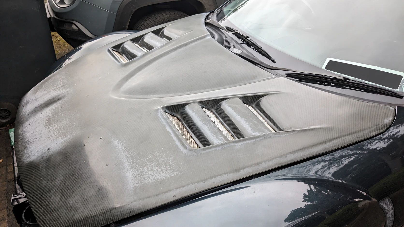 RX-8 carbon bonnet during restoration, with a dull and cloudy surface